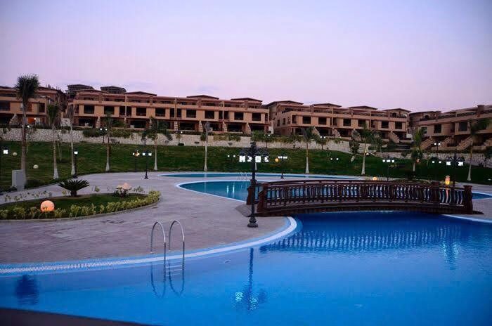 Resort pool with bridge at dusk